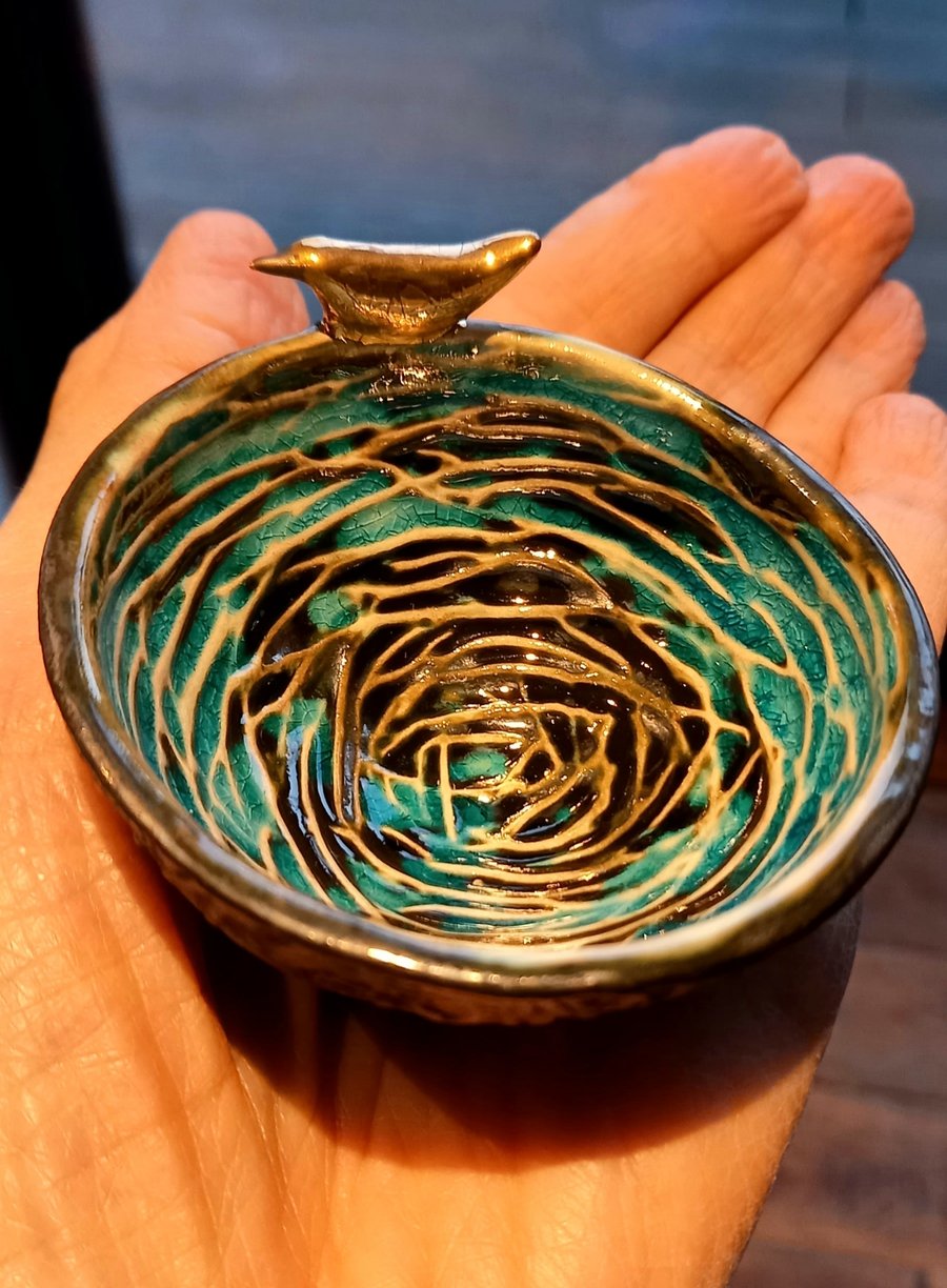 Small birds nest bowl with bird