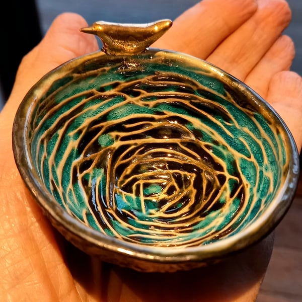 Small birds nest bowl with bird