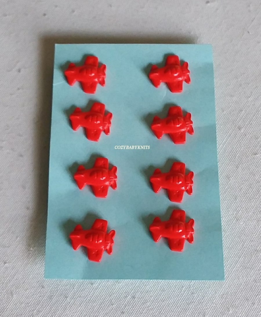 RED PLANE BUTTONS WITH A SHANK ON THE BACK FOR ATTACHING 