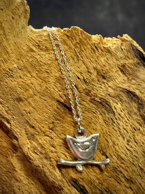 Silver bird sitting on twig pendant 