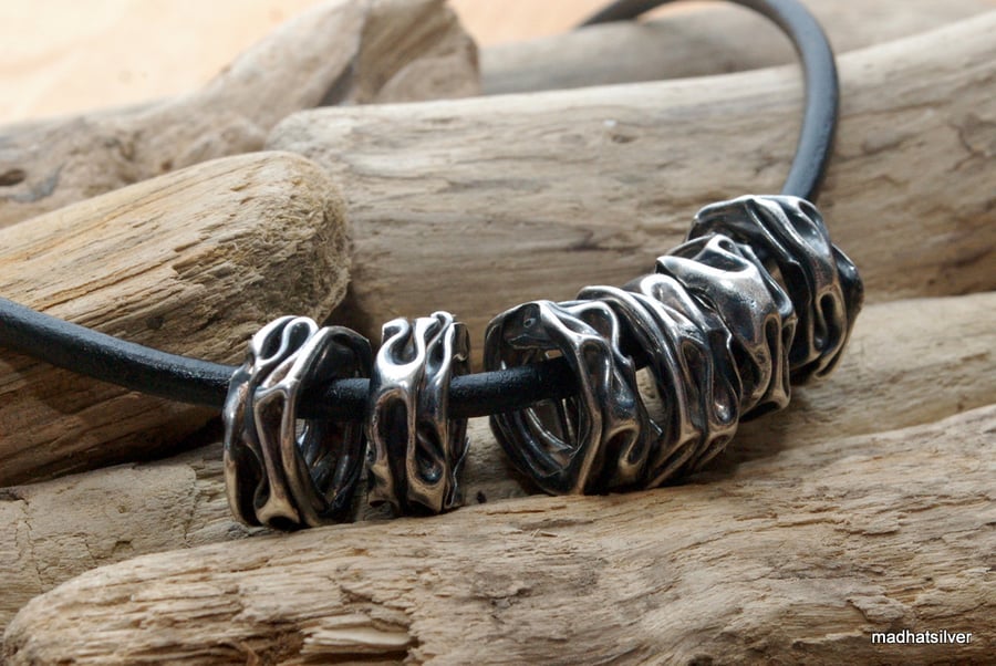 Sterling silver folded beads on black leather, silver pendant, silver beads