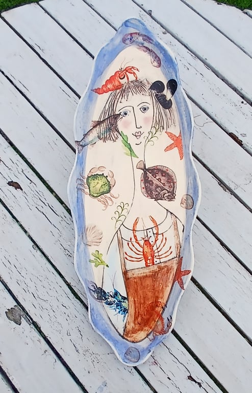 Figurative shallow dish with fish.