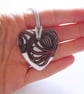 Filigree Artwork Design on Heart Shaped Ceramic Pendant on Grey Cord - Image 1