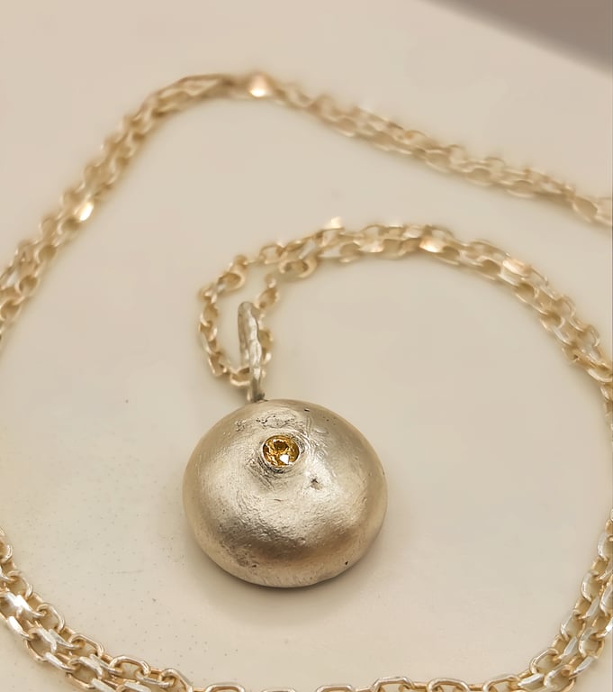 Molten Silver Pebble Pendant with Yellow Sapphire