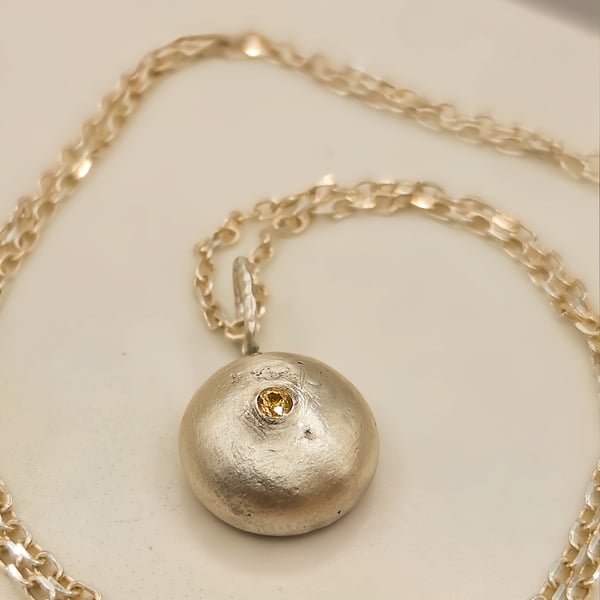 Molten Silver Pebble Pendant with Yellow Sapphire