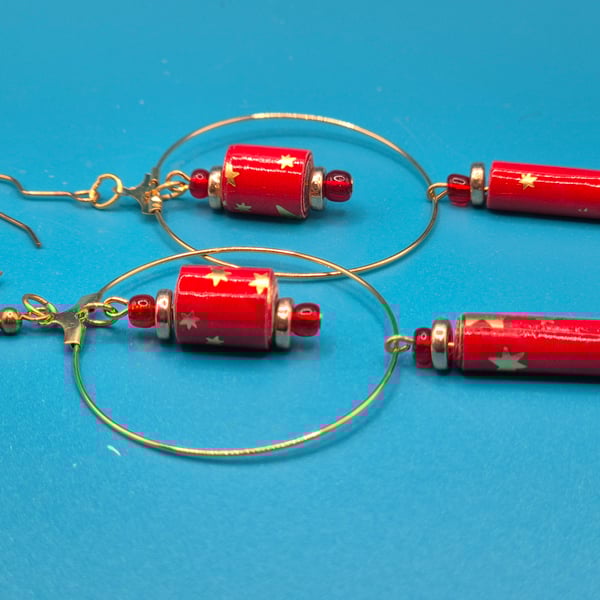 Large golden hoop earrings with dangling handrolled red and gold paper beads 
