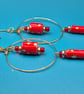 Large golden hoop earrings with dangling handrolled red and gold paper beads 