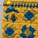 Exquisite and colourful crochet pouch with zipper fastening