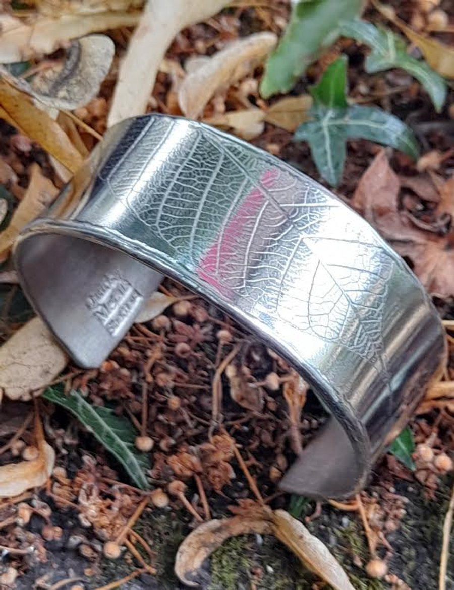 Polished Pewter Cuff Bangle with embossed leaf detailing. 