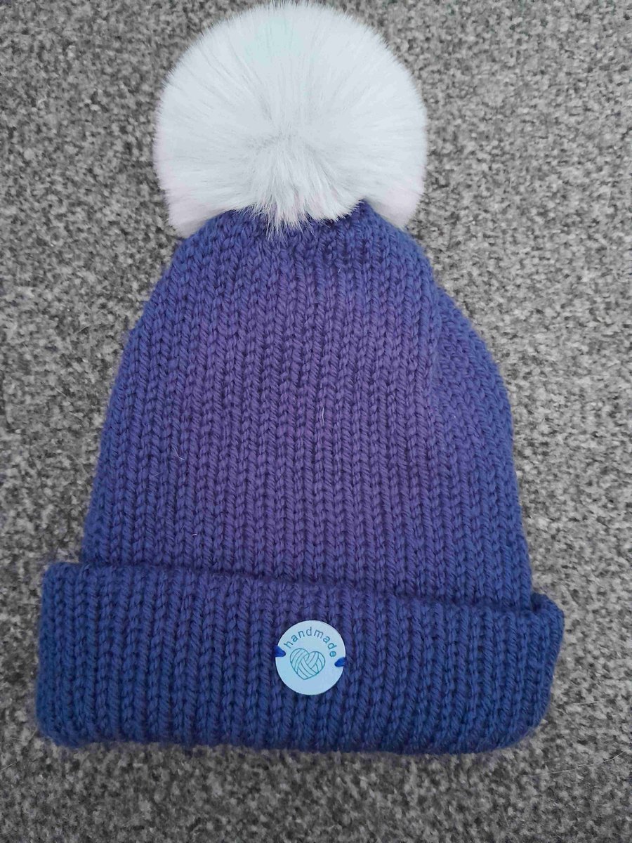 Navy blue beanie hat with light grey pom pom