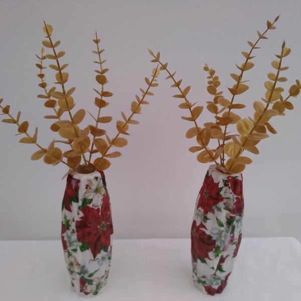 Pair of small decoupaged plastic vases filled with gold Eucaylptus