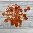 44 orange buttons, assorted shapes and sizes