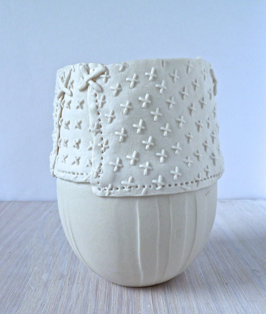 Delicate hand made porcelain vase with resist and impressed decoration. 