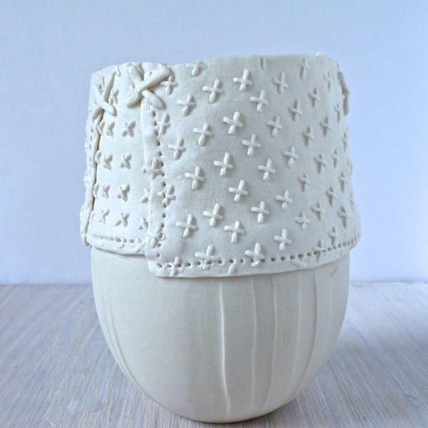 Delicate hand made porcelain vase with resist and impressed decoration. 