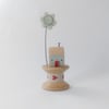 Tiny oak house with clay flower on vintage wooden bobbin