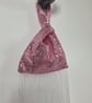 Pink sequin Japanese Knot bag with 27cm tassel trim and satin lining.