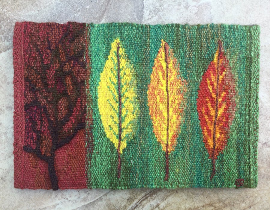 Mounted handwoven tapestry weaving, textile art in red, green, orange and yellow