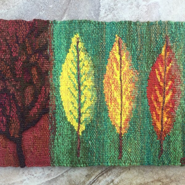 Mounted handwoven tapestry weaving, textile art in red, green, orange and yellow