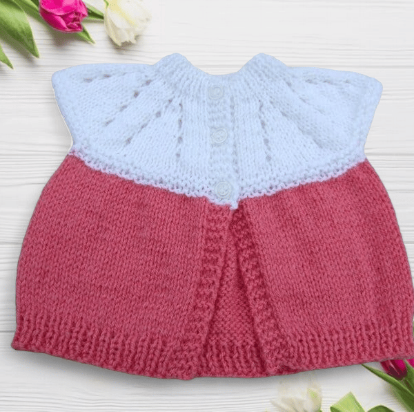 Baby sleeveless cardigan hand knitted in white and deep pink