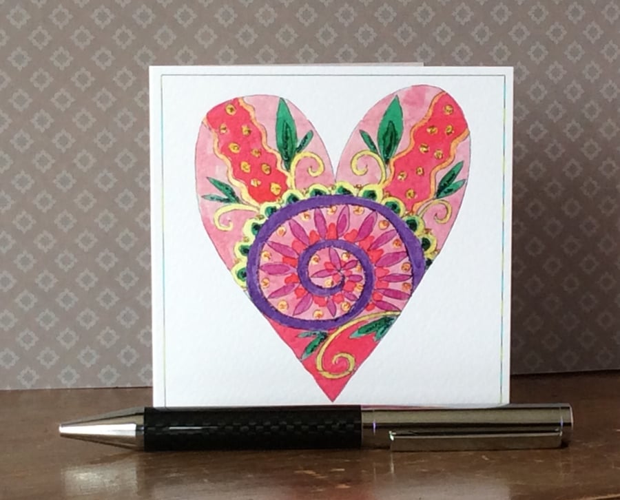 Decoratively patterned hand painted love heart printed card. 