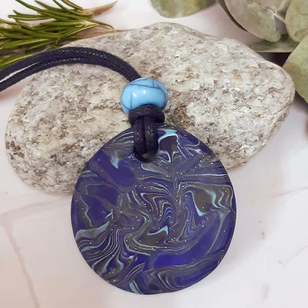 Round blue polymer clay pendant