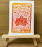 Maple Leaf Lino Print Greeting Card - Orange and Red - Image 1