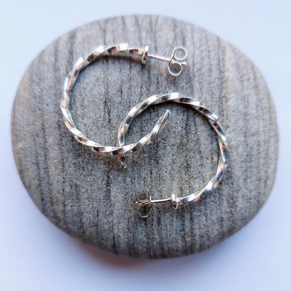 Sterling silver stud hoop earrings made from twisted square wire.