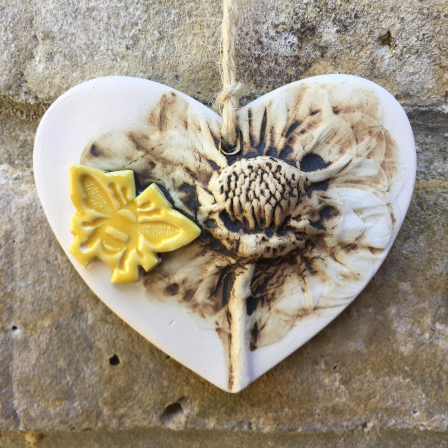 Pottery heart decoration with natural flower design and bee