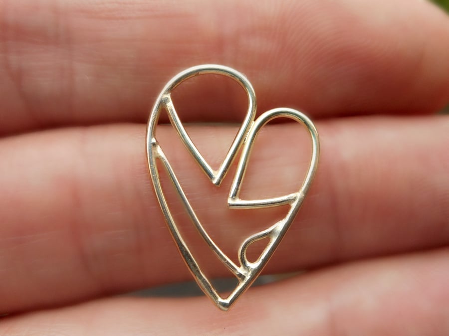 A personalised bespoke solid gold pendant made from a drawing of a sculpture