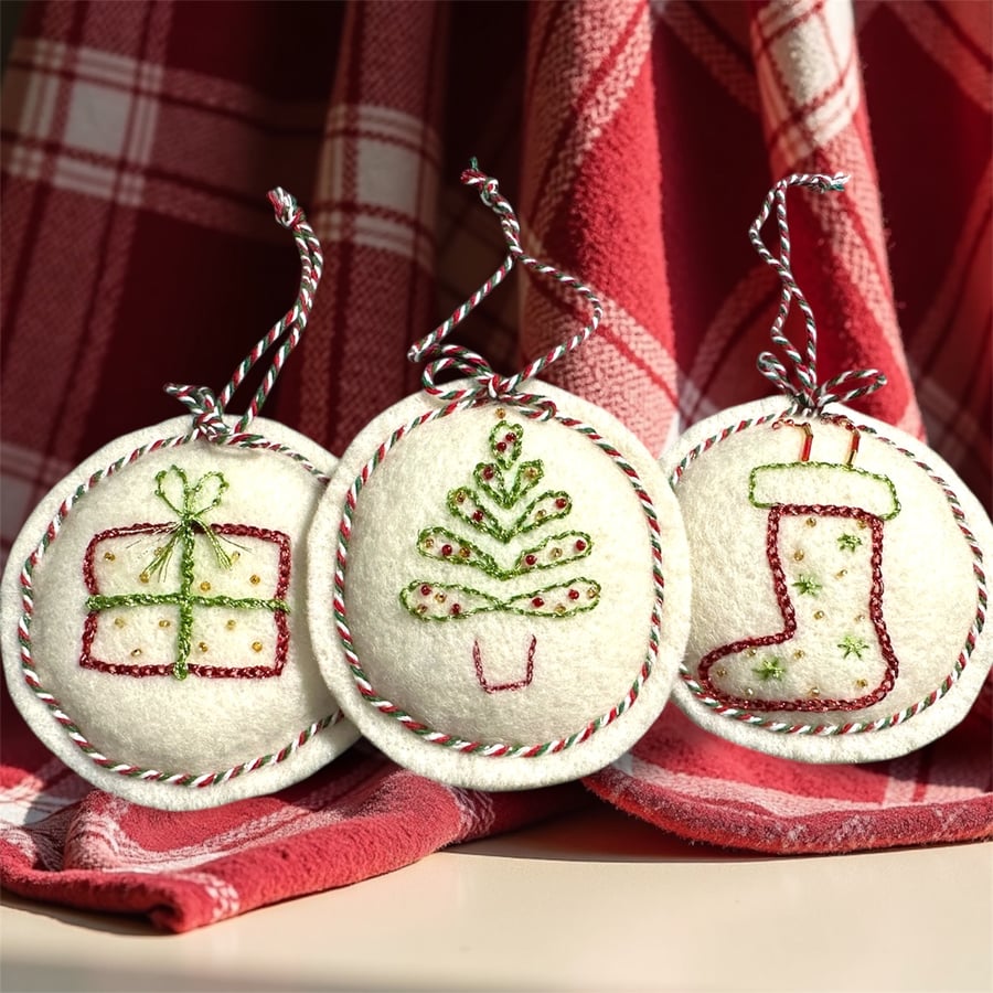 A trio of wool felt hanging decorations, baubles,stocking, gift,tree, candy cane