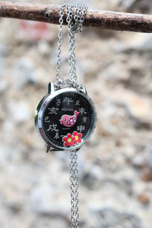 Upcycled Chinese words watch dial with movable flower beads and bird necklace