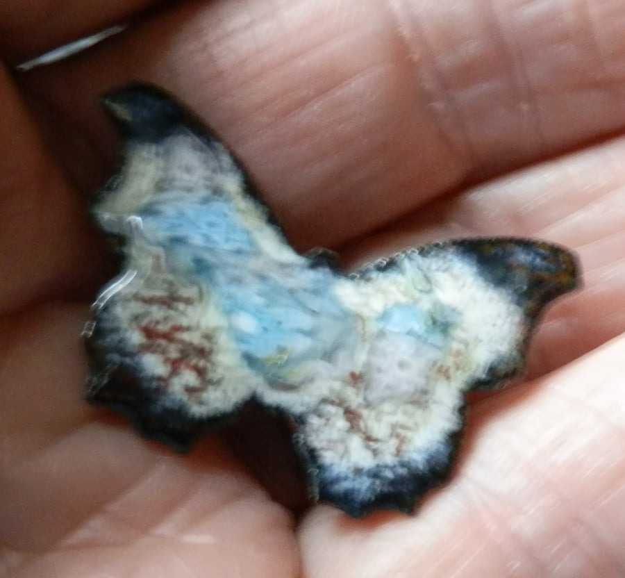 Butterfly brooch, enamelled white, wing tips black, wings patterned ...