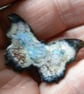 Butterfly brooch, enamelled white, wing tips black, wings patterned blue and red