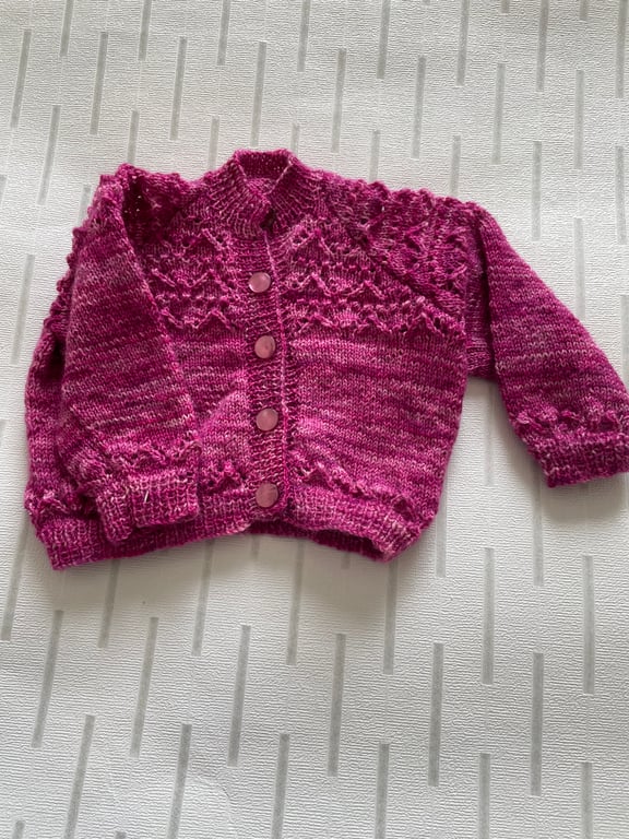 Baby cardigan with lacy pattern knitted in a hand dyed yarn 