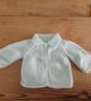 Hand knitted mint baby cardigan with collar for age 0-3 months.