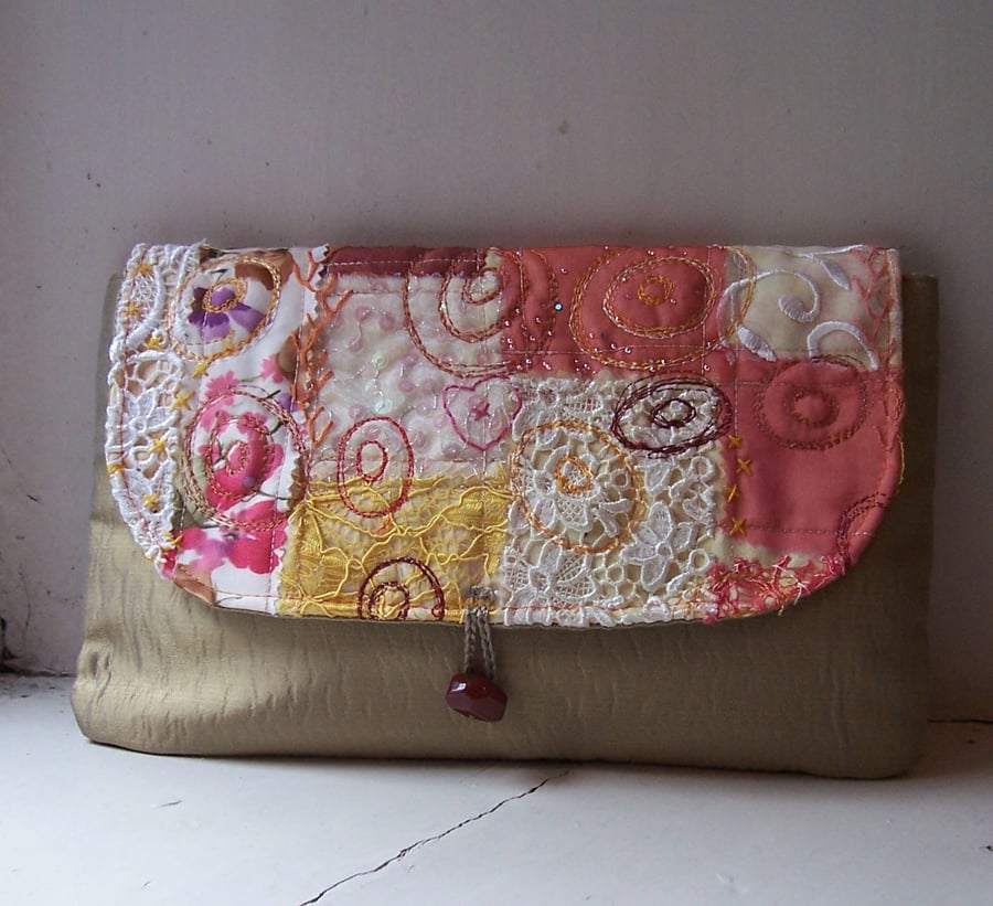 Fabric clutch bag with textile art flap and vintage bead closure 