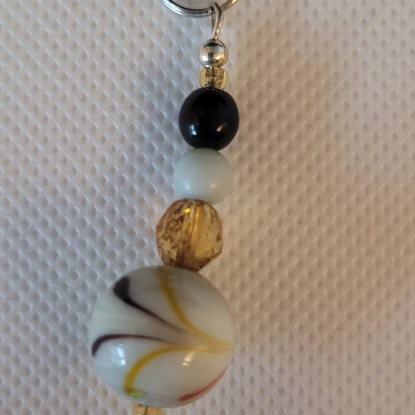 White and amber coloured beaded bag or phone charm