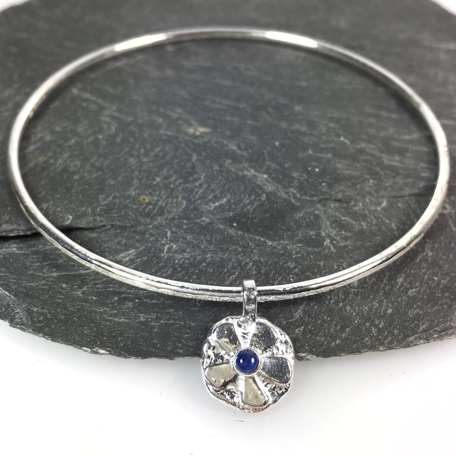 Sterling silver round bangle with sapphire set flower charm