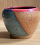 Petite plant pot speckled buff clay with blue green glaze and a pop of coral red