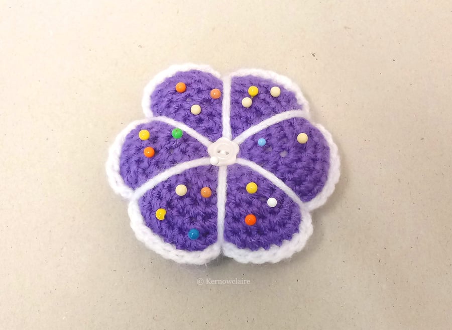 Pin cushion in a purple flower pattern, handmade sewing accessory