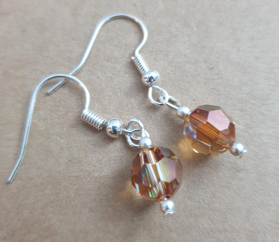 swarovski 8mm round faceted copper coloured beads on silver plated earrings