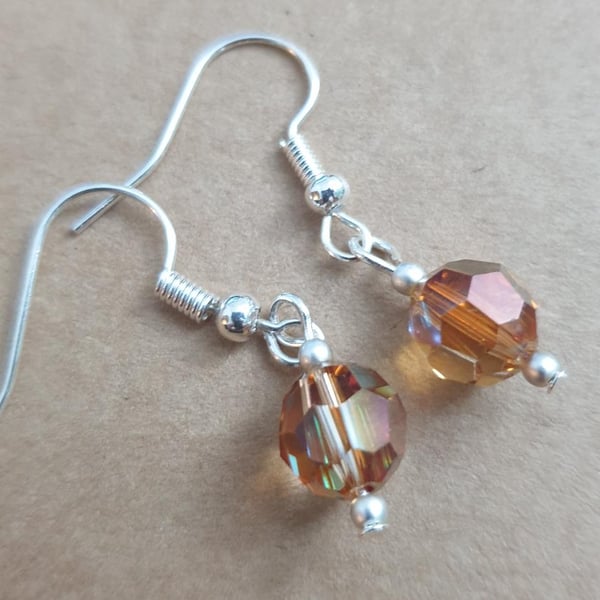 swarovski 8mm round faceted copper coloured beads on silver plated earrings