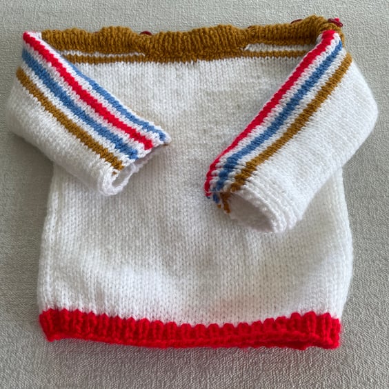 White jumper with coloured stripes 