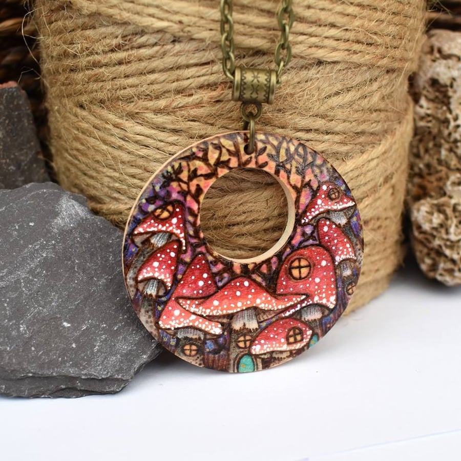 Pyrography toadstool town pendant. Large fairy house circle necklace.