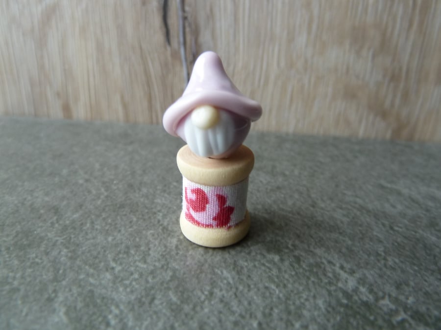 wooden spool with pink gnome