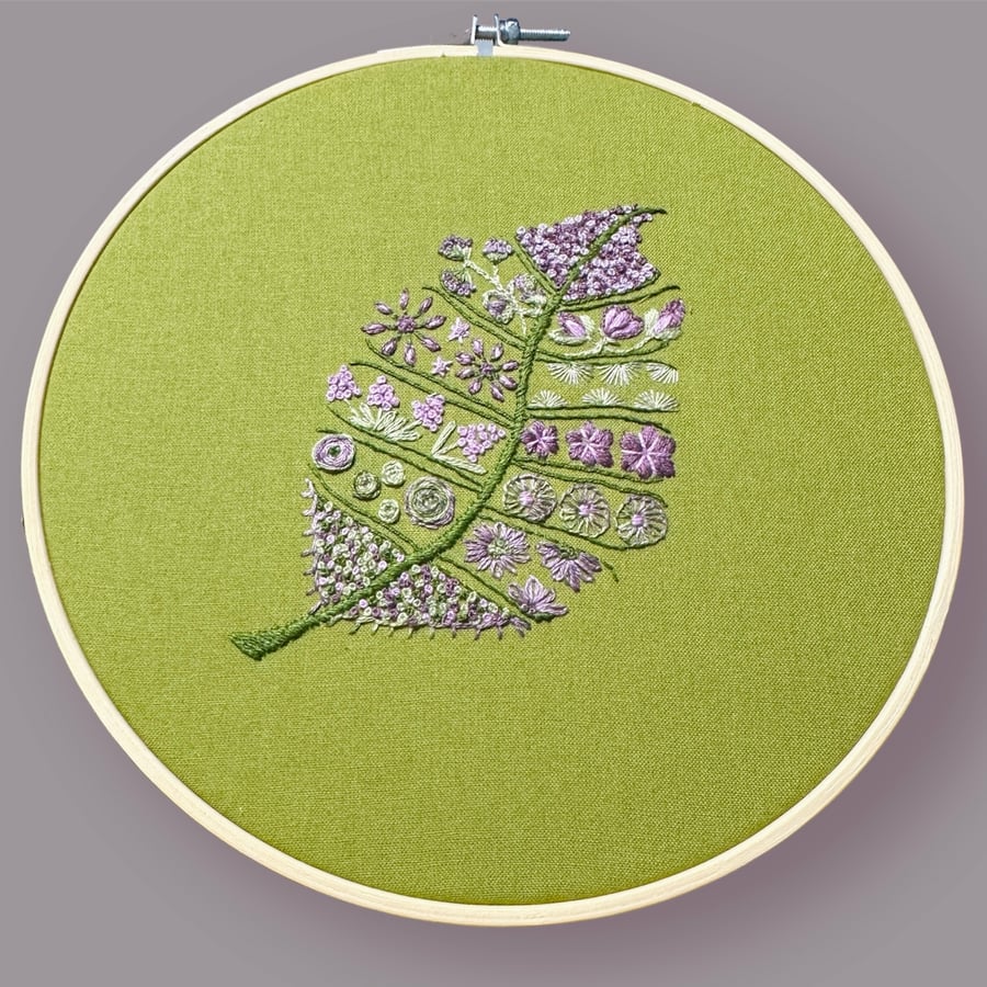 Gorgeous textile art embroidered abstract floral leaf picture in a beech frame. 