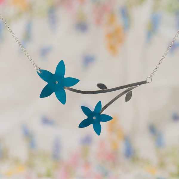 Two wildflowers on a silver stem necklace