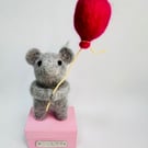 Handcrafted needle felted mouse holding a balloon on a wooden box