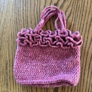 Small frilly woollen crochet handbag in a raspberry red