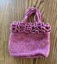 Small frilly woollen crochet handbag in a raspberry red